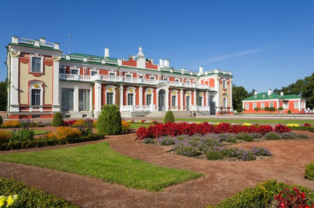 Red and white exterior of Kadriorg Palace with garden