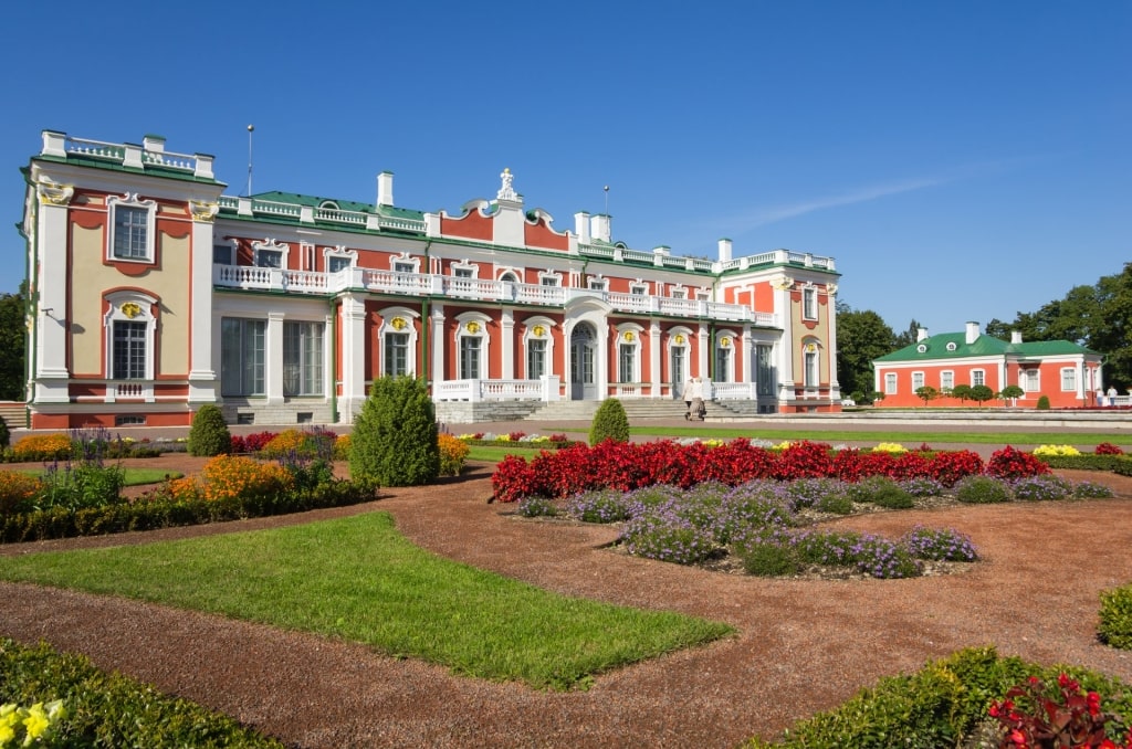 Red and white exterior of Kadriorg Palace with garden