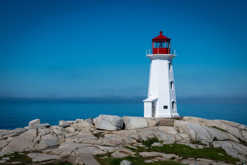 White and red facade of Peggy’s Point Lighthouse