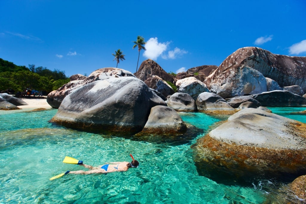 Woman snorkeling in the turquoise waters at The Baths