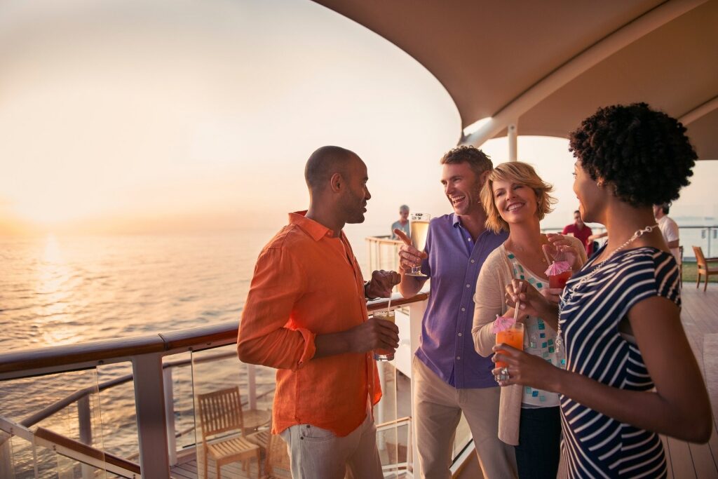People hanging out over drinks on a cruise