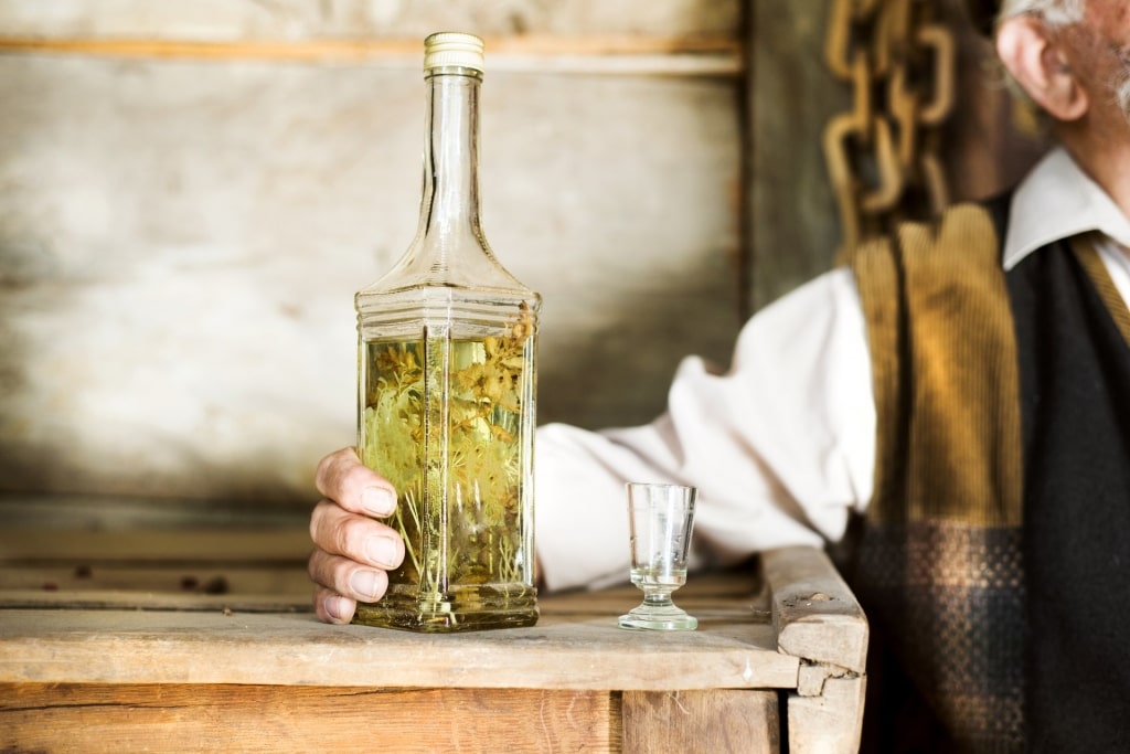 Man holding a bottle of Aquavit