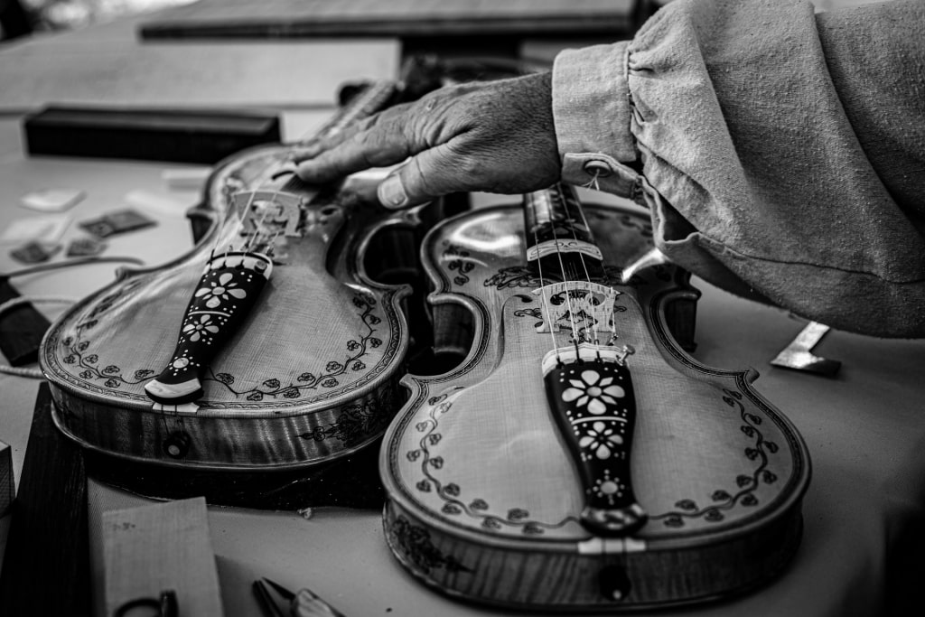 Man holding Hardanger fiddles