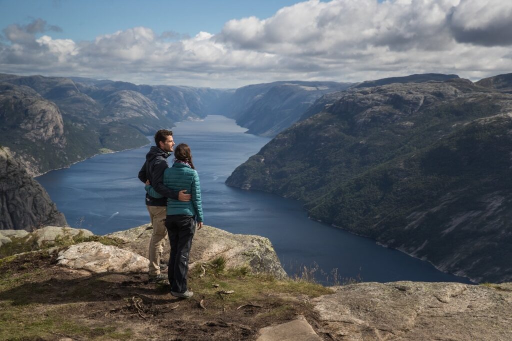 Couple sightseeing from Preikestolen Pulpit Rock in Norway