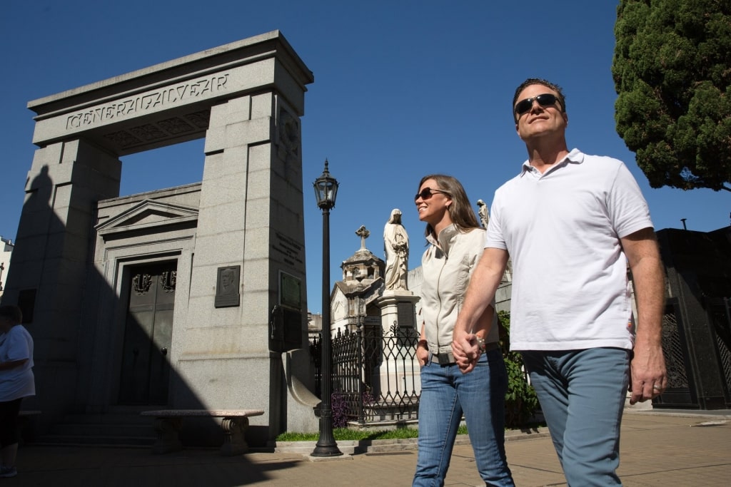 Couple walking along Recoleta Cemetery