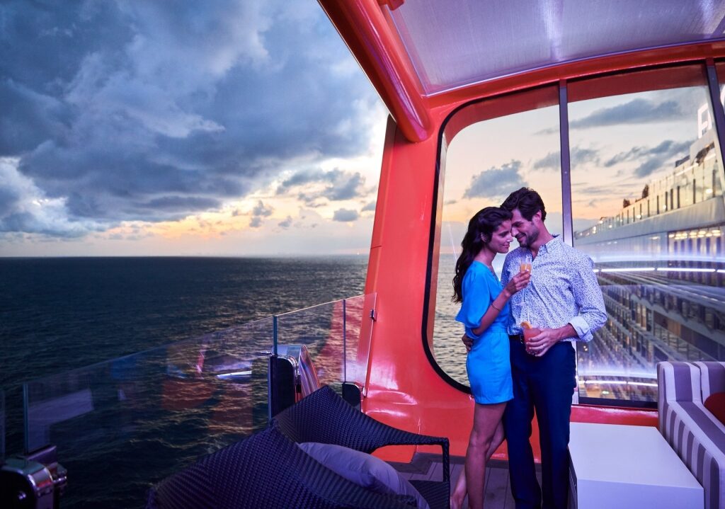 Couple drinking cocktails at Magic Carpet on Celebrity Edge on a closed loop cruise