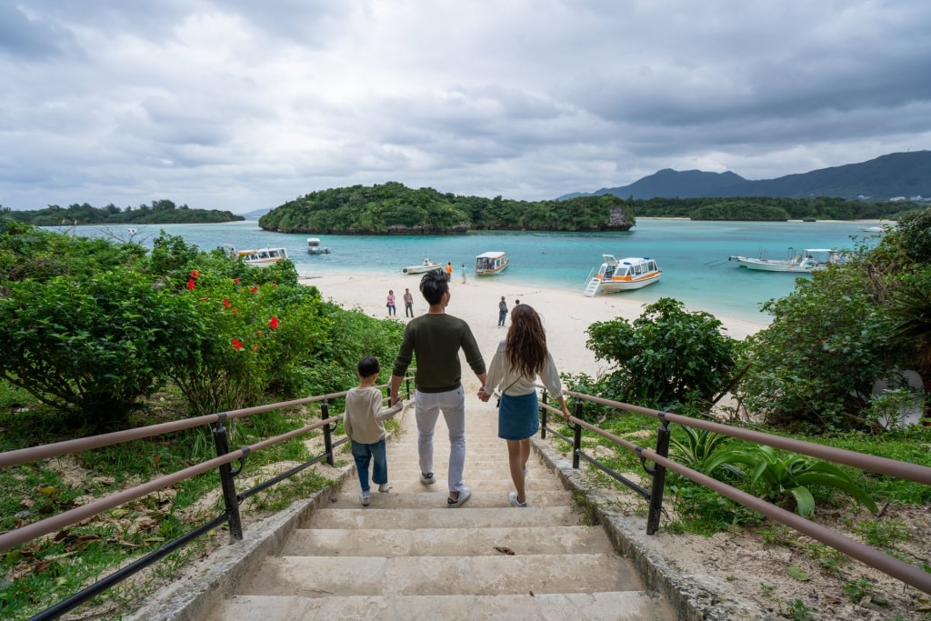 Family walking down the stairs with scenic view of Kabira Bay