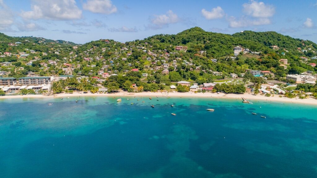 Picturesque shoreline of Grand Anse Beach with lush trees