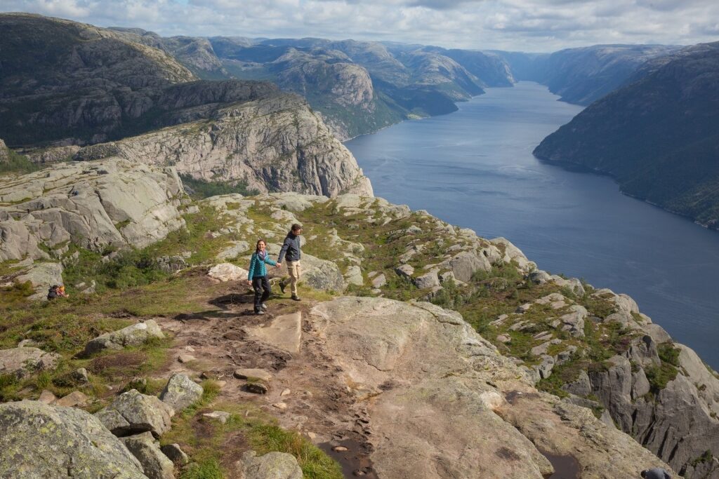 Couple hiking Pulpit Rock in Norway