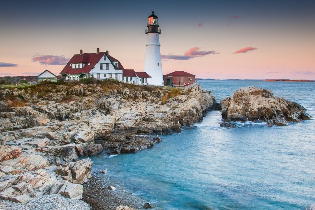 Beautiful landscape of lighthouse with house on rocky coastline