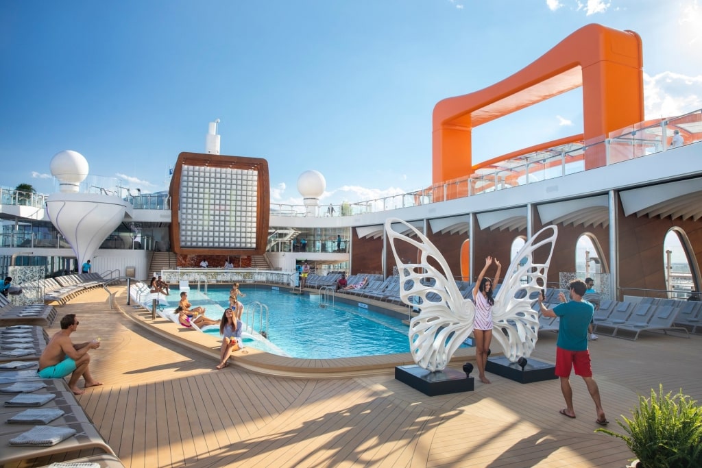 People relaxing by the pool on a cruise