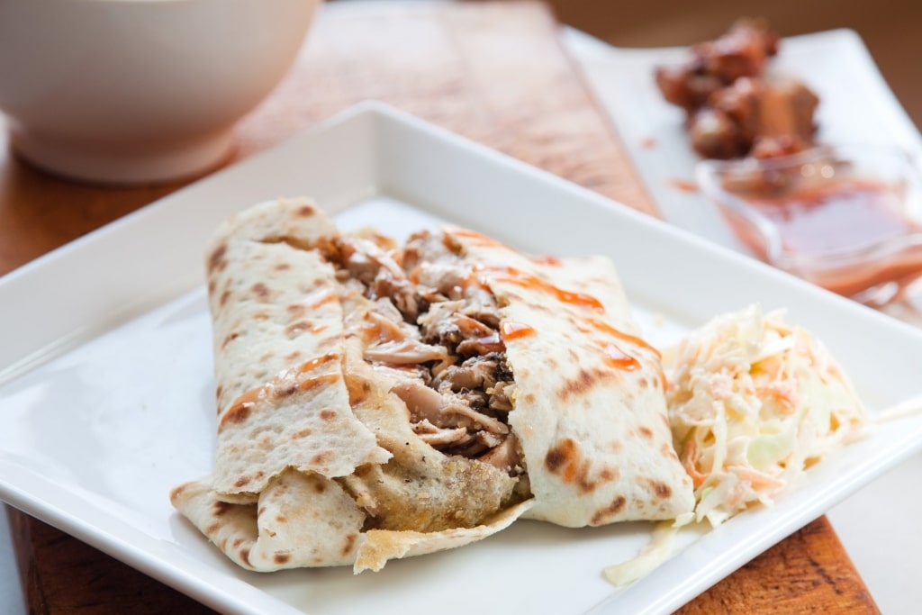 Plate of savory roti, one of the best Barbados food