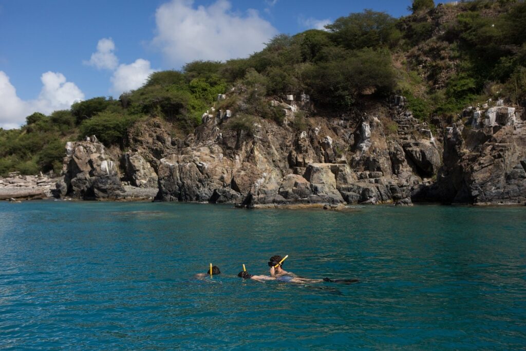 People snorkeling by the famous Creole Rock