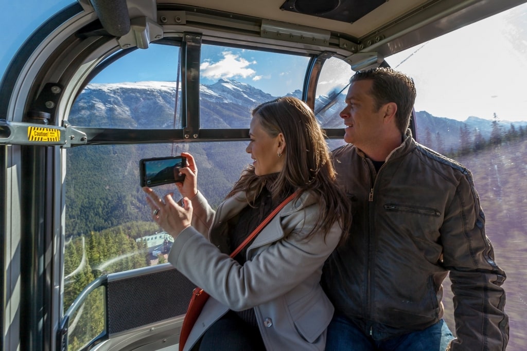 Couple in a gondola ride up to Sulphur Mountain