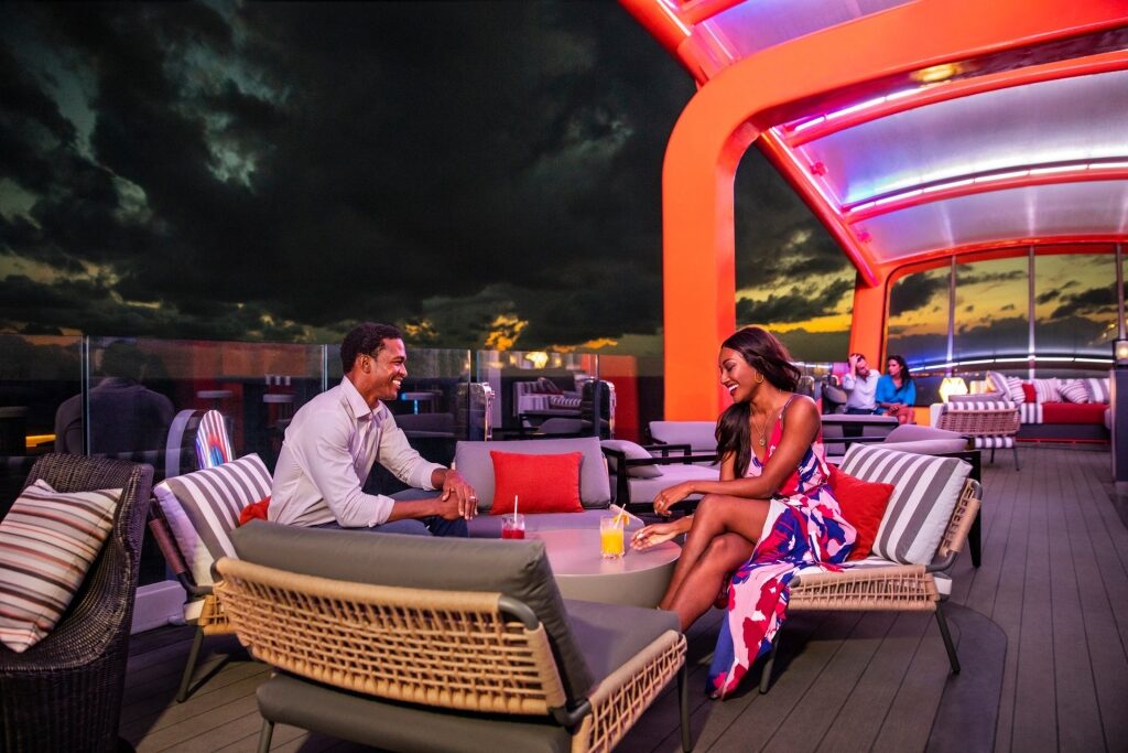 Couple hanging out over drinks in Magic Carpet