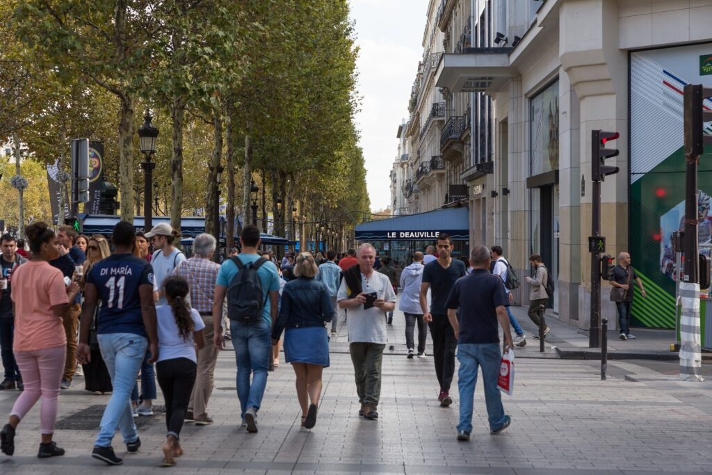 People browsing the shops along Champs-Élysées in Paris, France