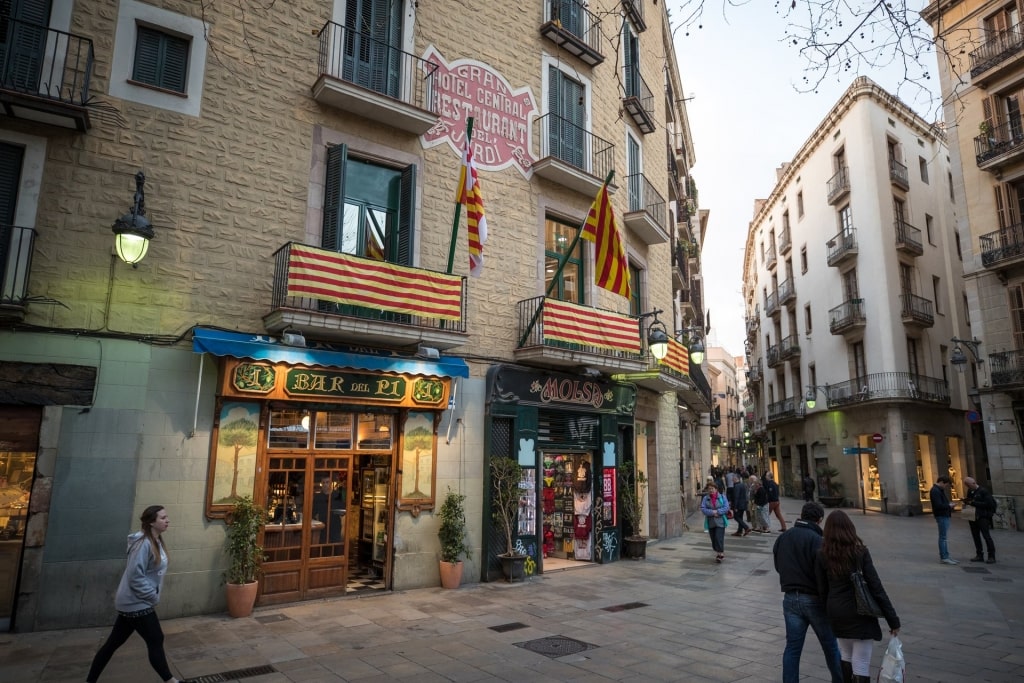 People walking along the Gothic Quarter with small shops