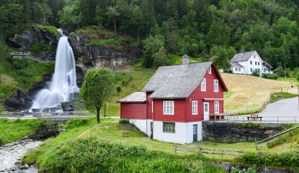 Beautiful view of Steinsdalsfossen waterfall with red house
