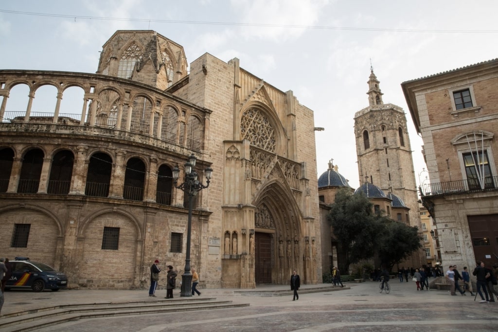 People walking along Valencia Cathedral, Spain