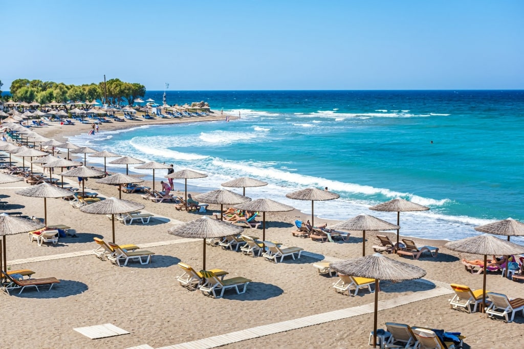 Secluded beach of Kamiros with beach umbrellas