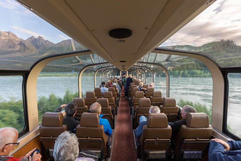 People inside a glass-domed train in Anchorage, Alaska