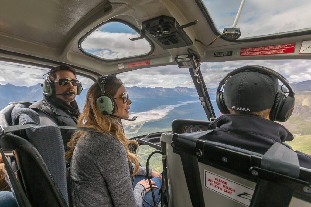 Couple inside a helicopter for glacier sightseeing in Denali