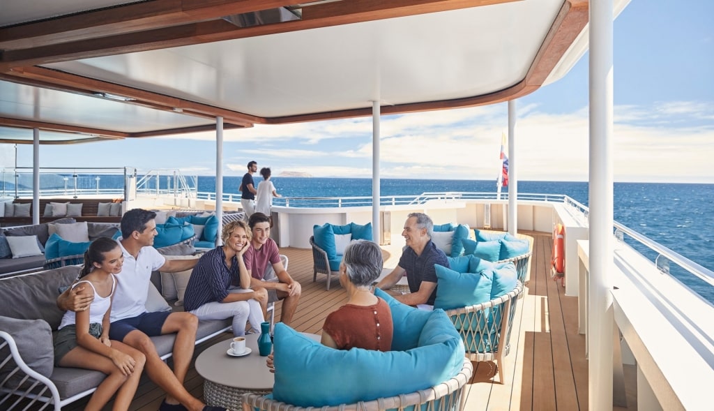 Cruises for large families - family hanging out on a cruise deck