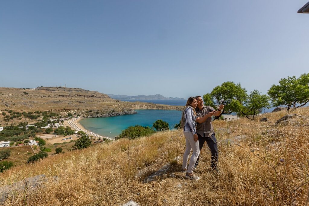 Couple taking a selfie from Lindos, Greece