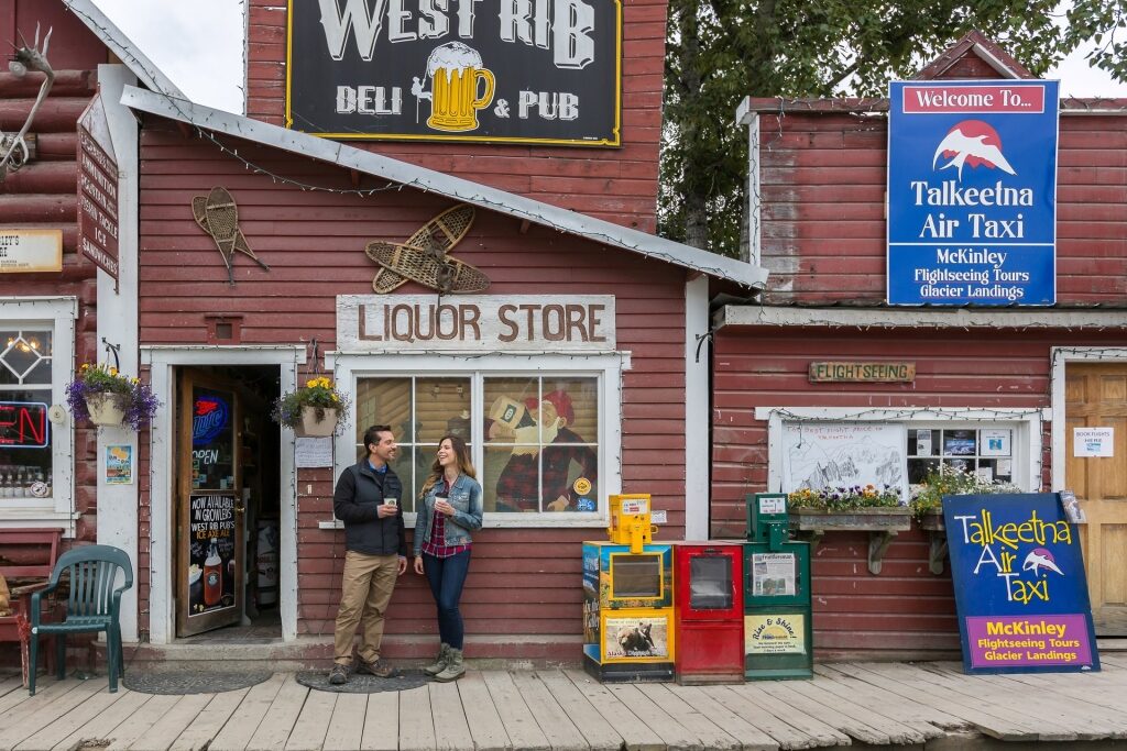Couple standing by the liquor store