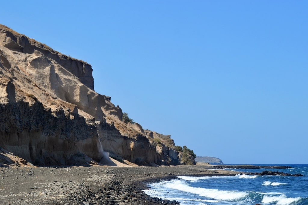 Black sands and calm waves of Vourvoulos Beach 