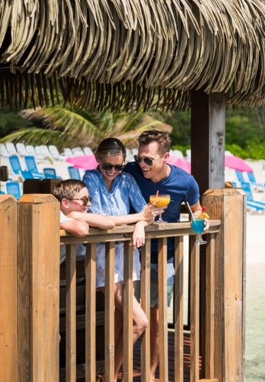 Family relaxing in Grand Cayman, one of the best family beach vacations in the world