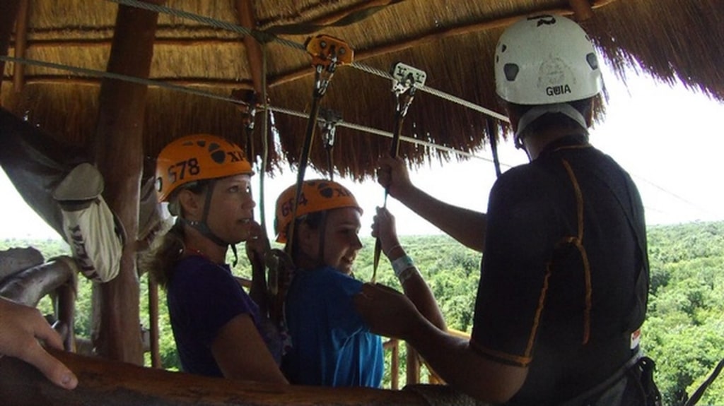 People getting ready for a zipline ride in Xplor