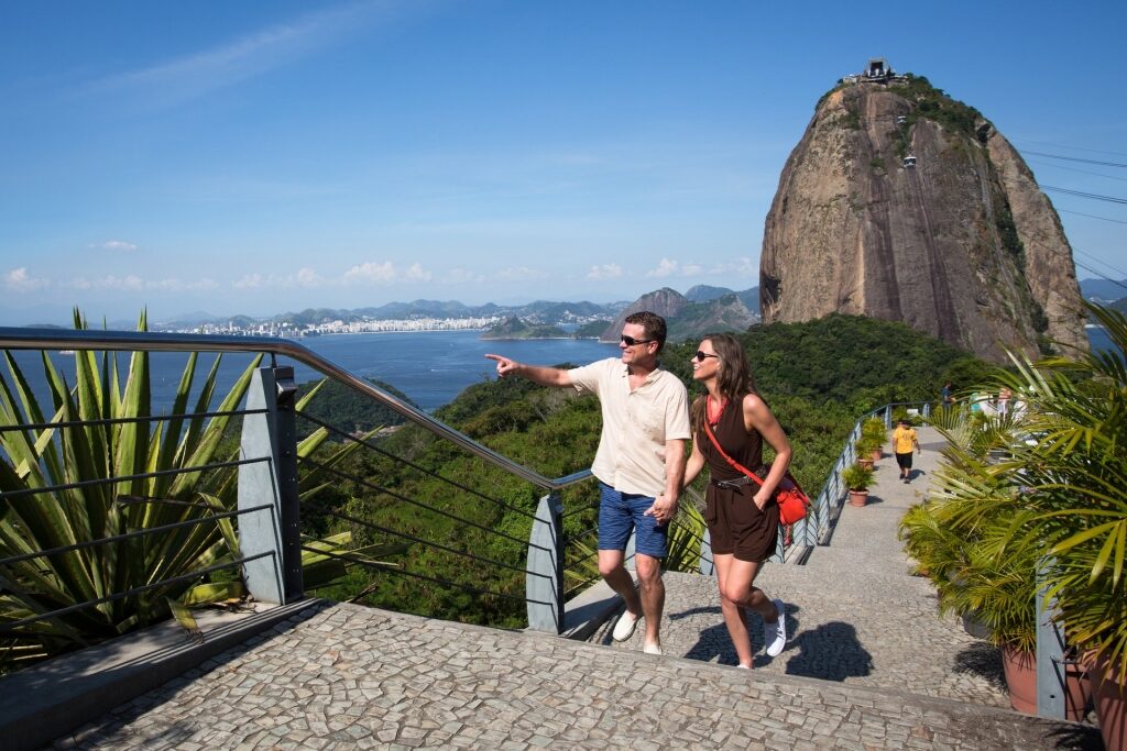 Couple sightseeing with Sugar Loaf Mountain as backdrop