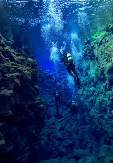 Divers in Silfra Fissure, one of the best diving spots in the world