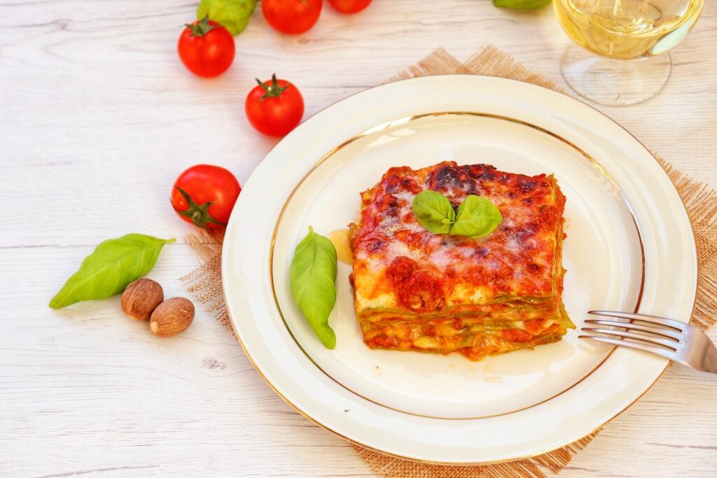 Plate of lasagna verdi with cherry tomatoes