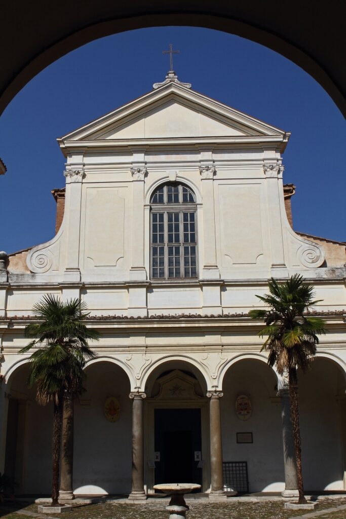 Cream and white facade of San Clemente Basilica