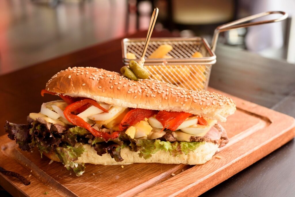 Try Chivito Sandwich, one of the best things to do in Montevideo