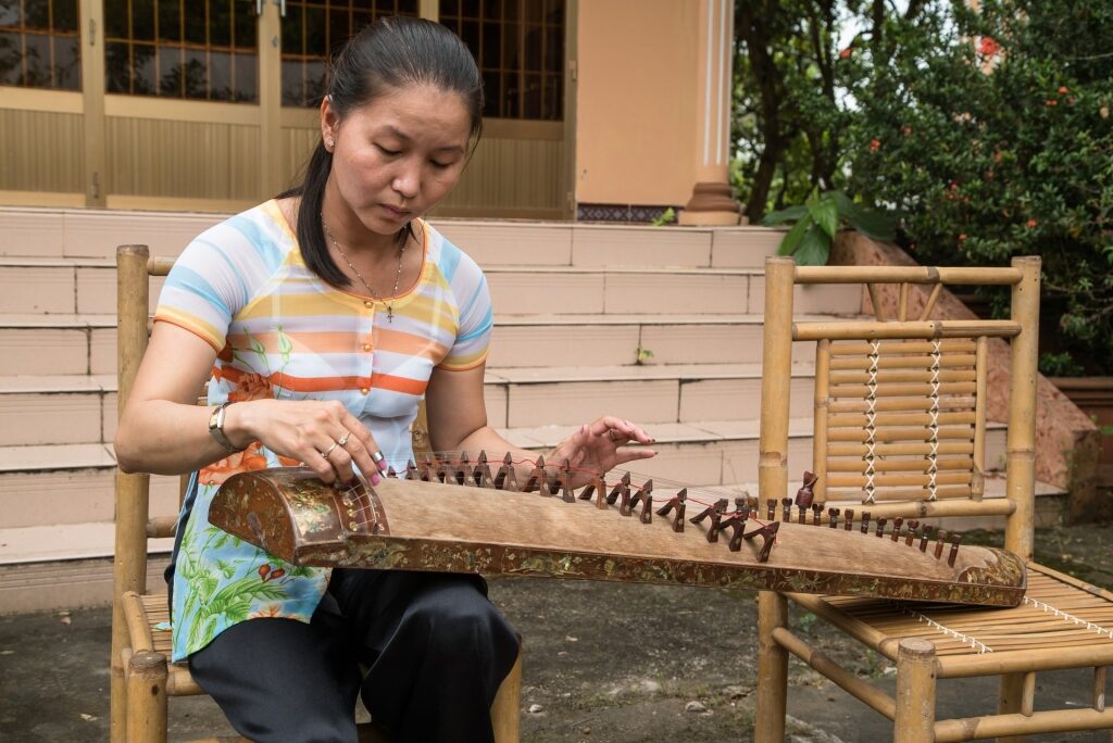 Woman playing a Vietnamese musical instrument