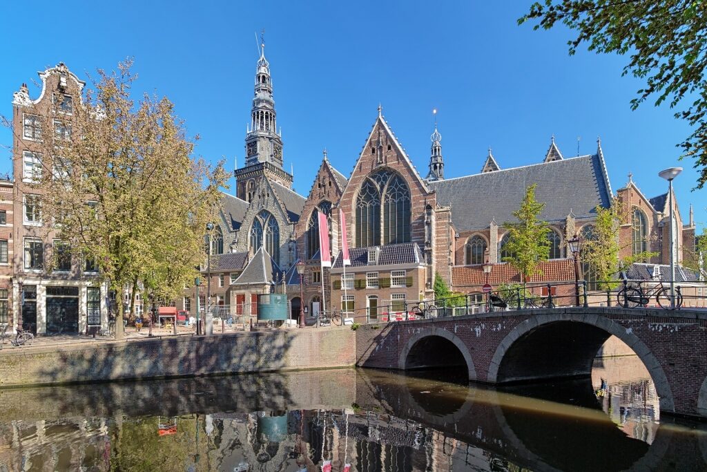 View of Oude Kerk with bridge along the canal