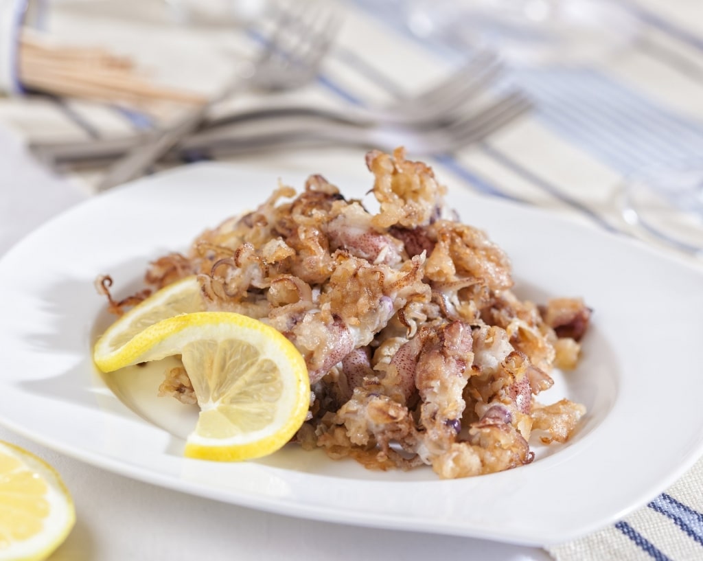 Deep fried chipirones garnished with lemon