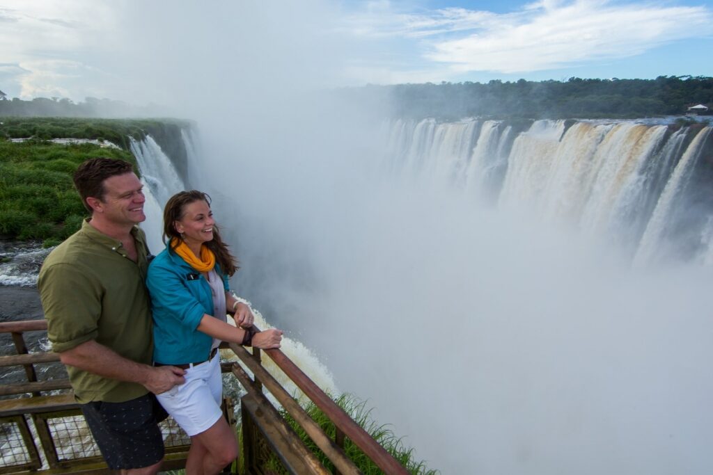 Couple looking at the majestic Iguazu Falls