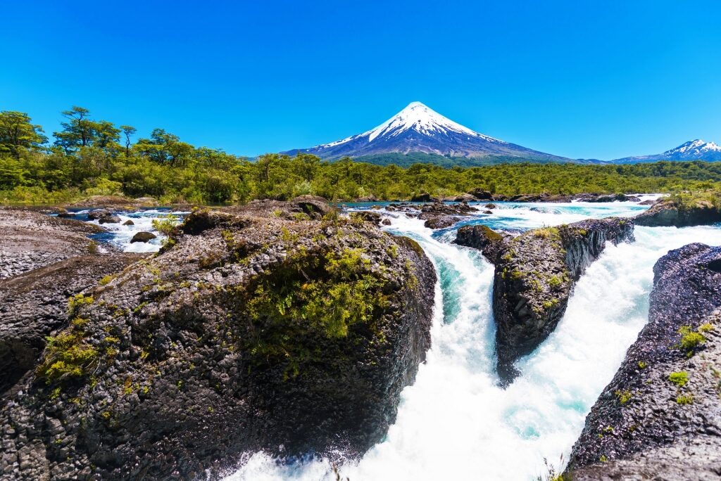 Scenic view of Petrohue waterfall with Mount Osorno in the background