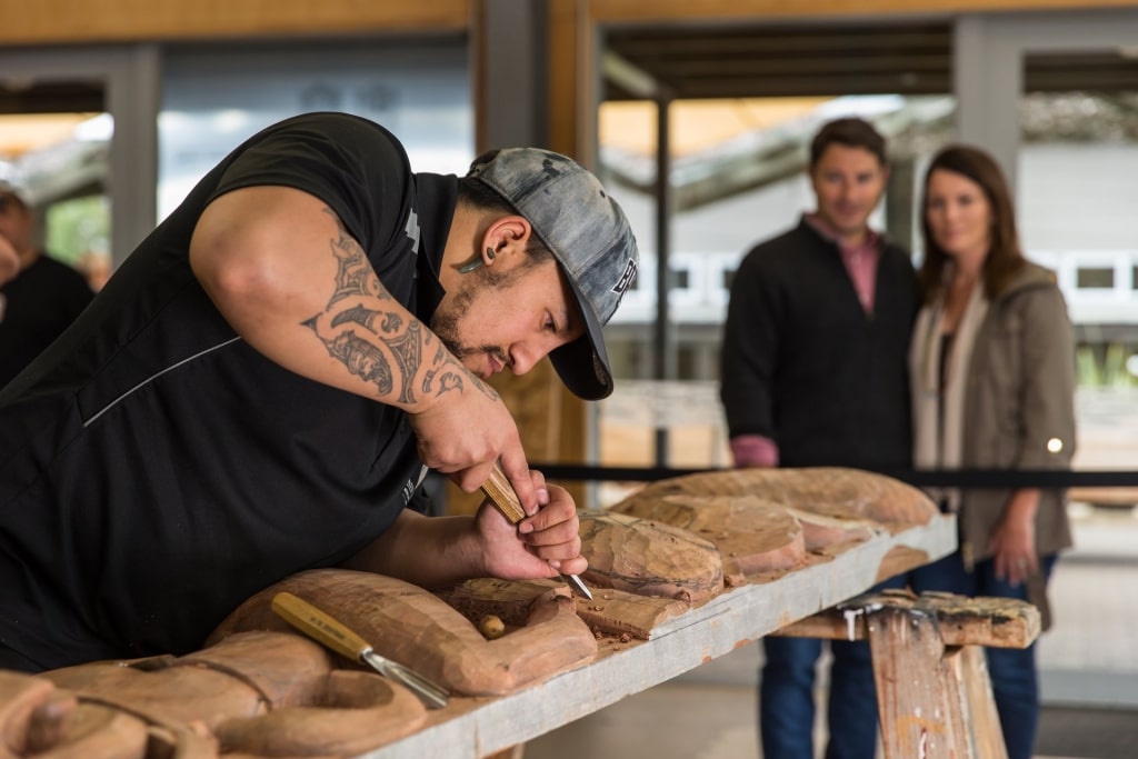 Woodcarving at a Maori village in the Te Puia Thermal Reserve 