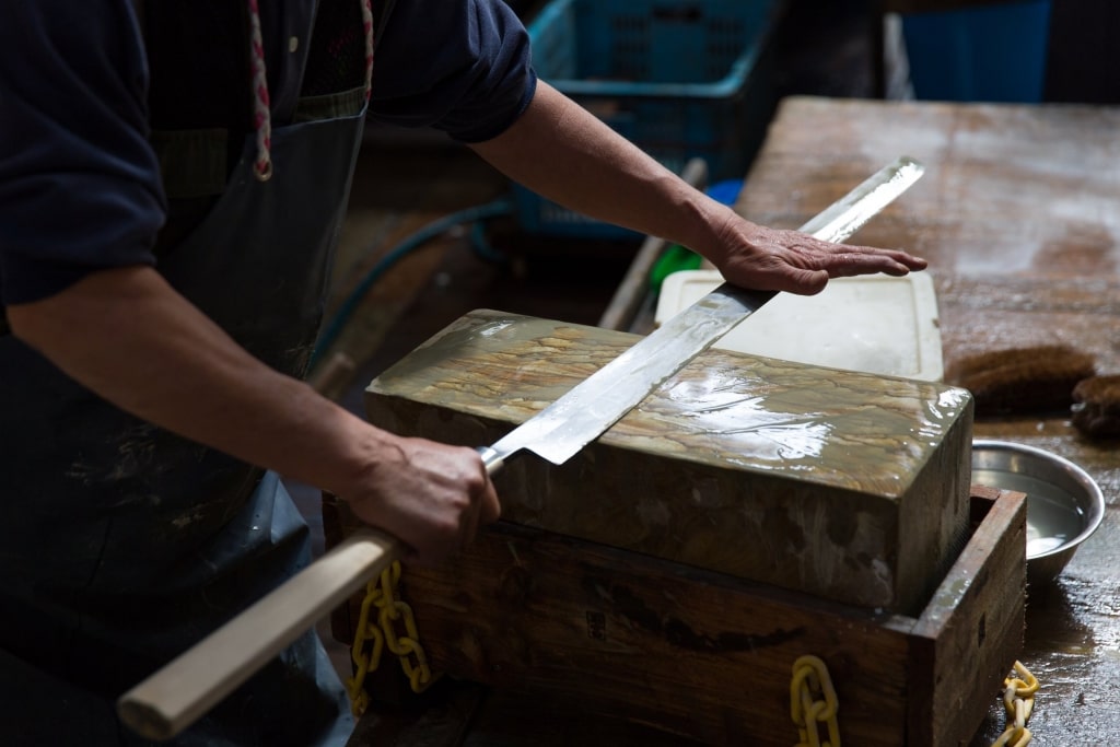 Merchant holding a big knife at the Tsukiji market