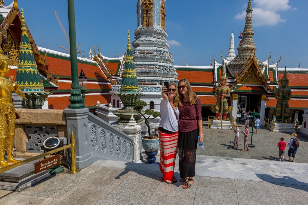 Women taking a picture from a temple in Bangkok