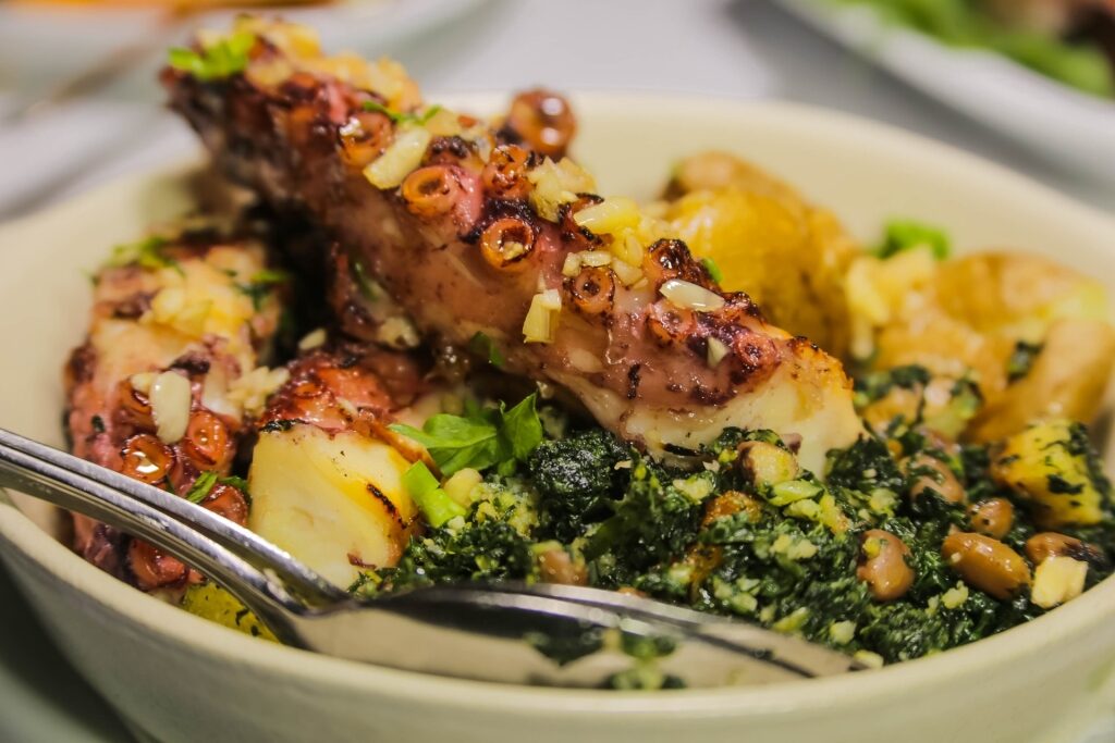 Bowl of polvo à lagareiro with potatoes