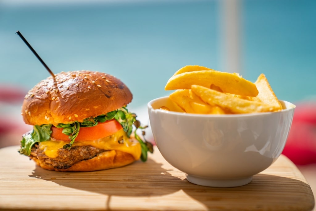 Meaty plate of Aruba burger with fries on the side