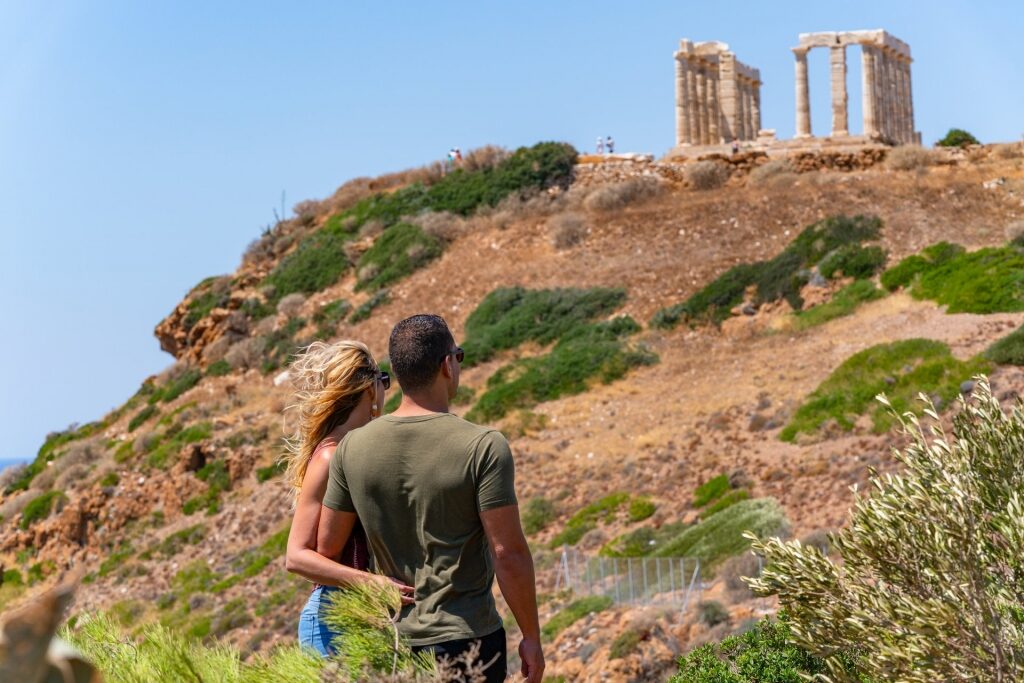 Couple sightseeing at the site of Temple of Poseidon