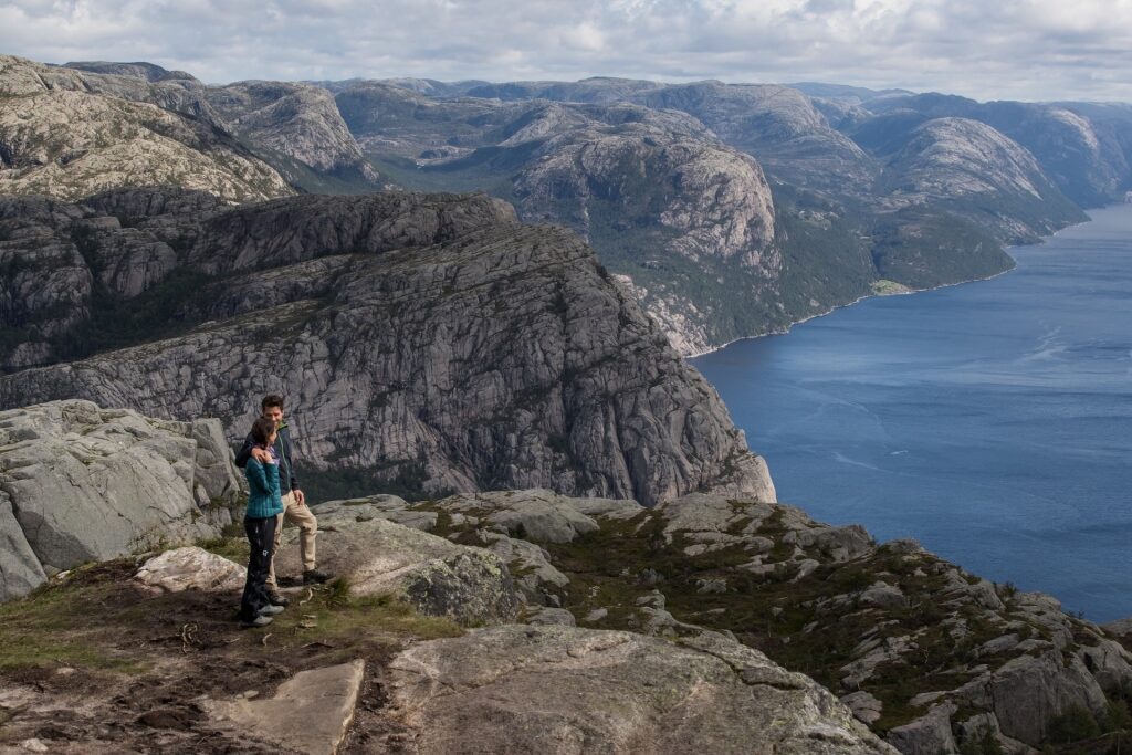 Couple sightseeing from Pulpit Rock in Norway