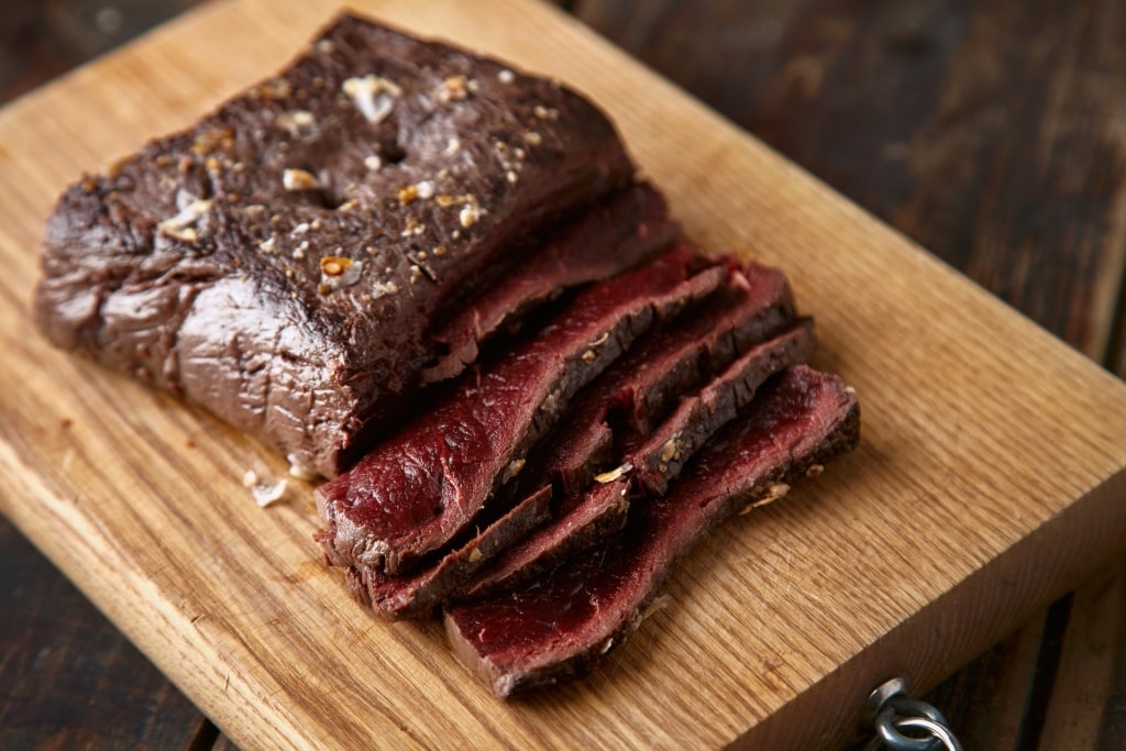 Slices of whale meat on a wooden board